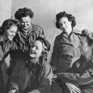 Marlene Dietrich in Uniform mit einer Gruppe von Angehörigen des Women's Army Corps im Hauptquartier der 12. Heeresgruppe in Frankreich.