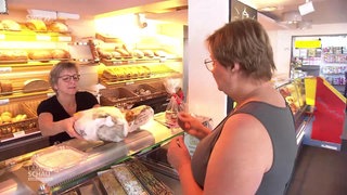 Eine Frau bezahlt in einer Bäckerei mit D-Mark